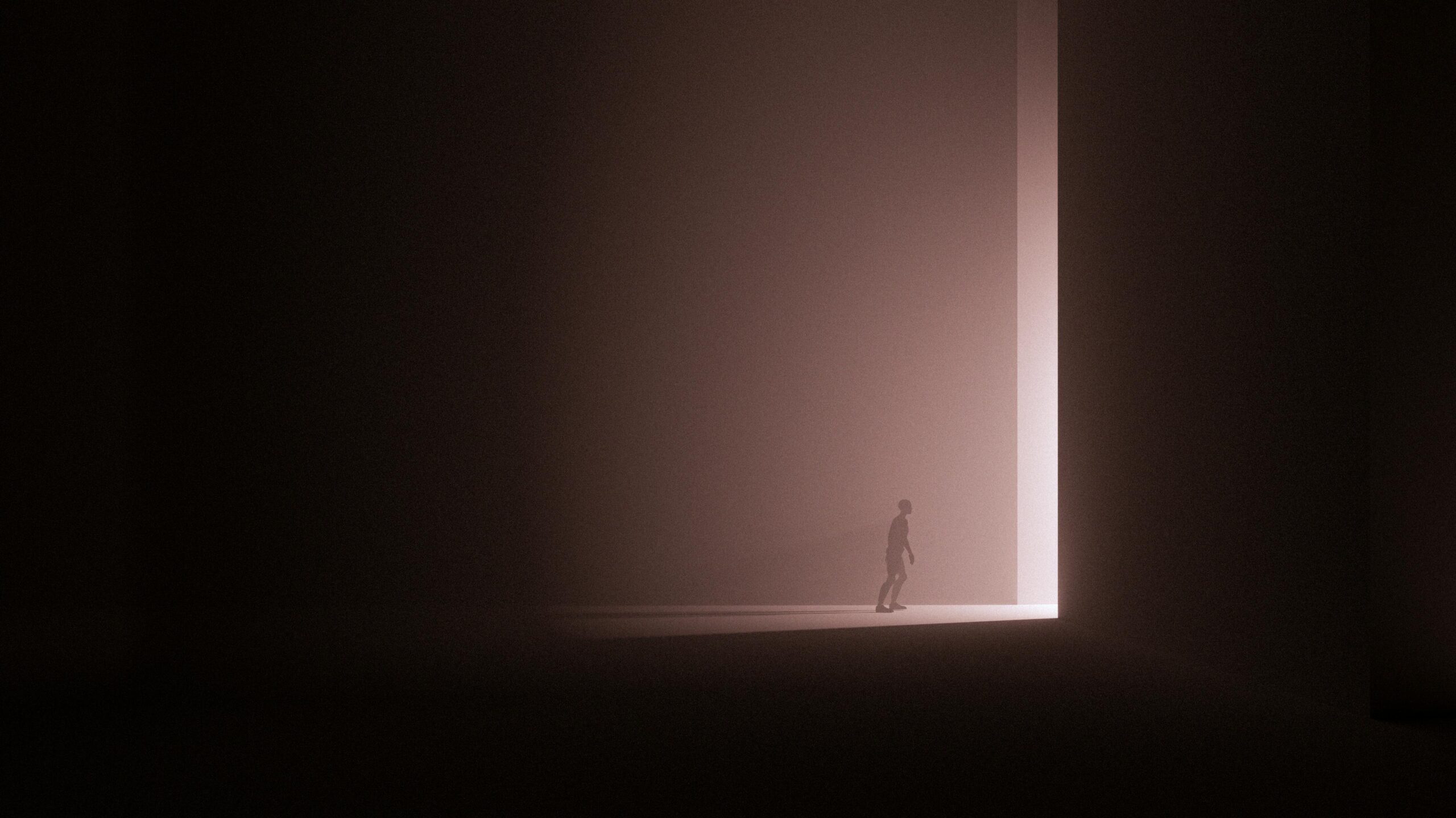 A man walking towards a portal of light.